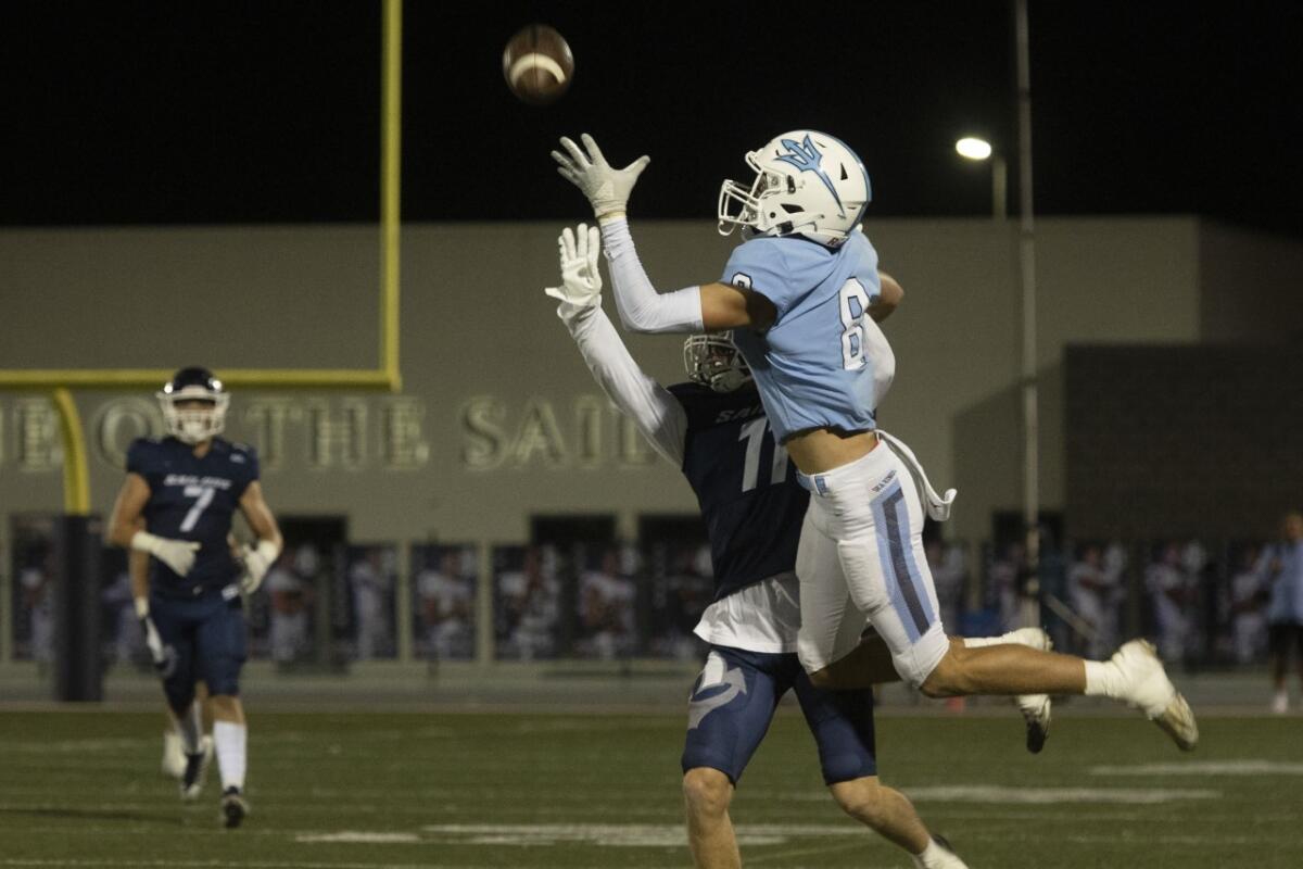 Corona del Mar’s Russell Weir hauls in a long pass during the Battle of the Bay against Newport Harbor on Friday night.