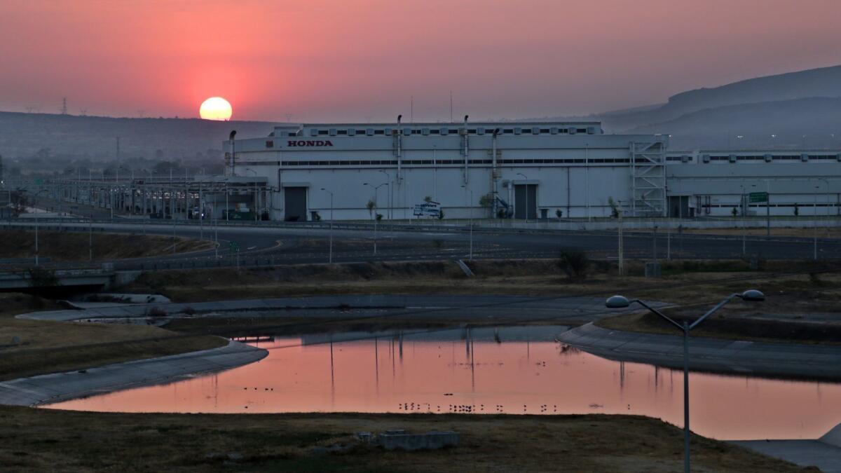 The sun rises over Honda automotive plants in Guanajuato. Hundreds of auto and parts factories have reshaped the region's agrarian landscape since NAFTA was signed in the mid-’90s.