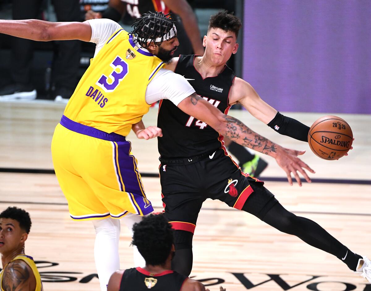 Lakers forward Anthony Davis forces Heat guard Tyler Herro into a turnover during Game 1.