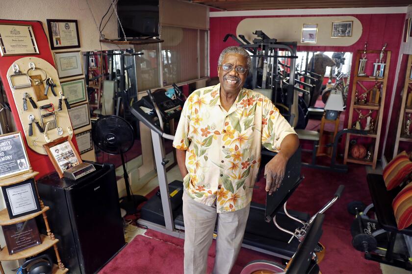 Harlen "Lamb" Lambert, 83, poses for a portrait at his home gym in Fullerton. Lamb was the first African American police officer in Orange County, working for the Santa Ana Police Department from 1967 to 1972. He recently wrote a memoir called "Badge of Color, Breaking the Silence." The book describes the difficult times Lamb had working on the police force and why he left law enforcement.