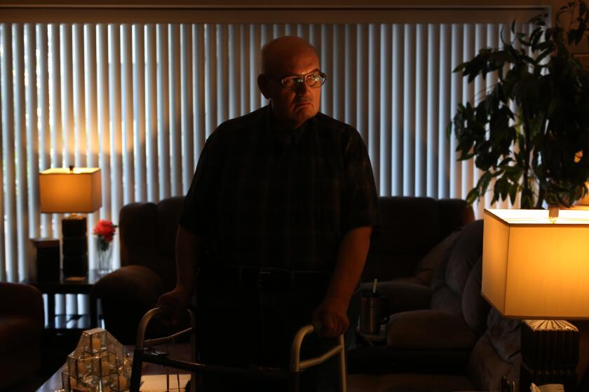 LOS ANGELES, CA - APRIL 27: Gregory Kuhl, 69, in an apartment where he has lived for forty years in Hollywood on Monday, April 27, 2020 in Los Angeles, CA. He uses a wheelchair outside his home and inside is able to get around short distances on his feet and with a walker. (Dania Maxwell / Los Angeles Times)