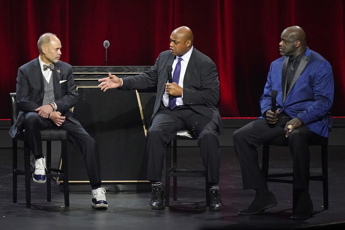Broadcasters Ernest Johnson Jr., Charles Barkley and Shaquille O'Neal on a set discussing basketball.