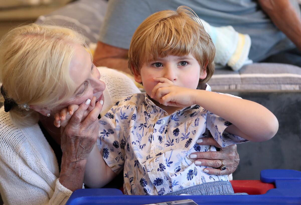 Andrew West reads a picture book with his grandmother Jan West in his Newport Beach home.