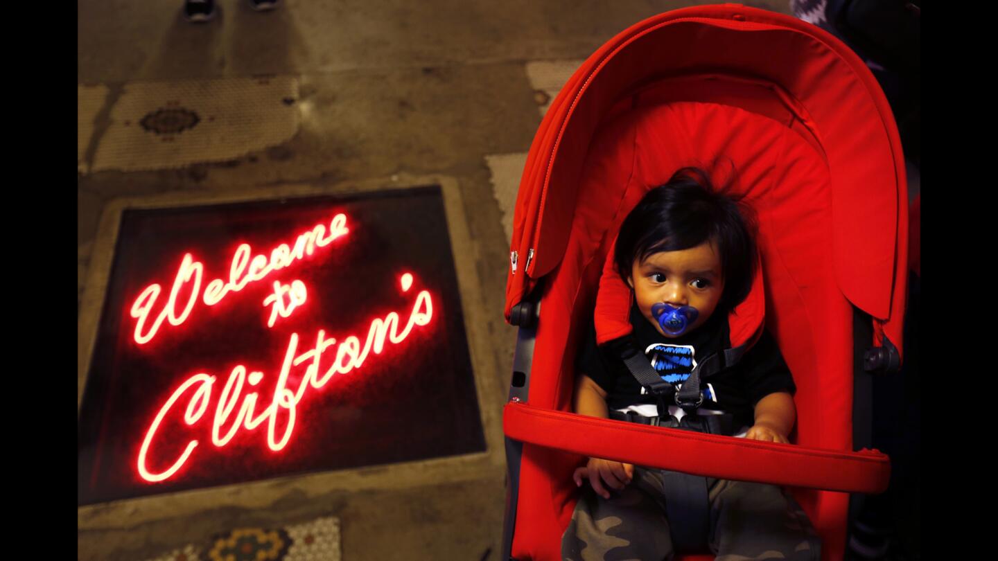Christopher Becerril, 7 months, sits in his stroller while his family goes through the line at Clifton's cafeteria, which has had a lot of people waiting to get in since it reopened Oct. 1.