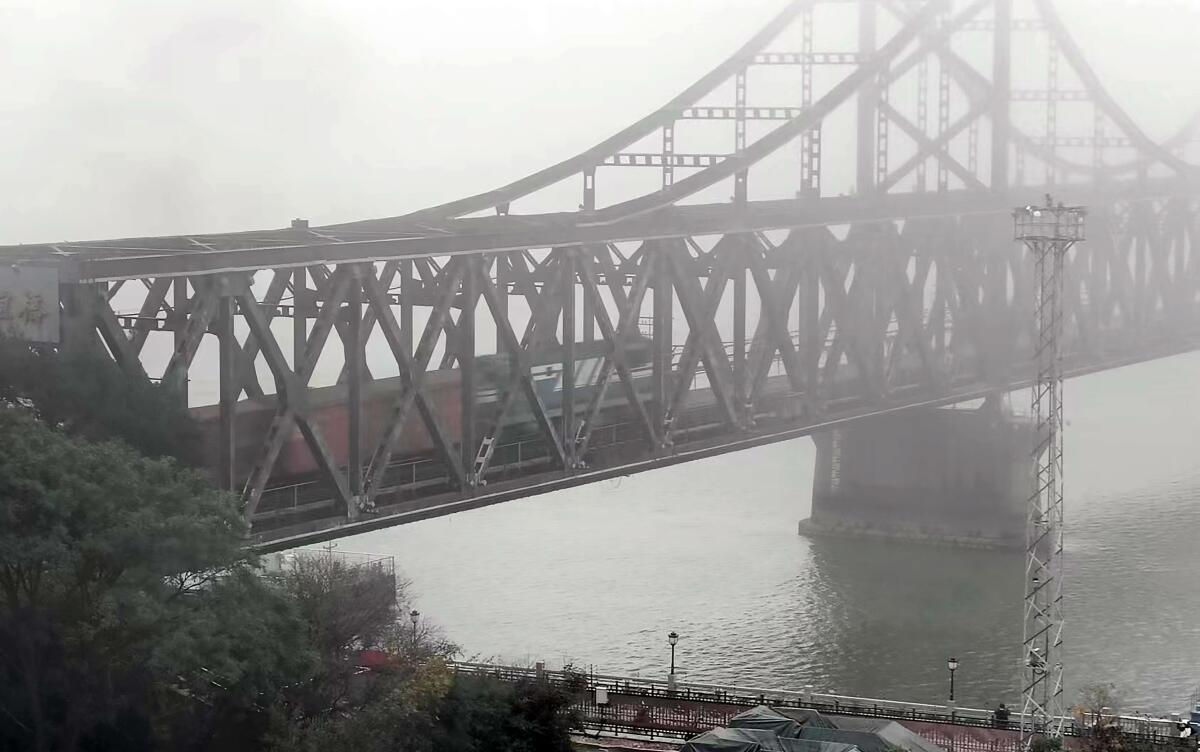 A freight train crosses a bridge connecting China and North Korea.