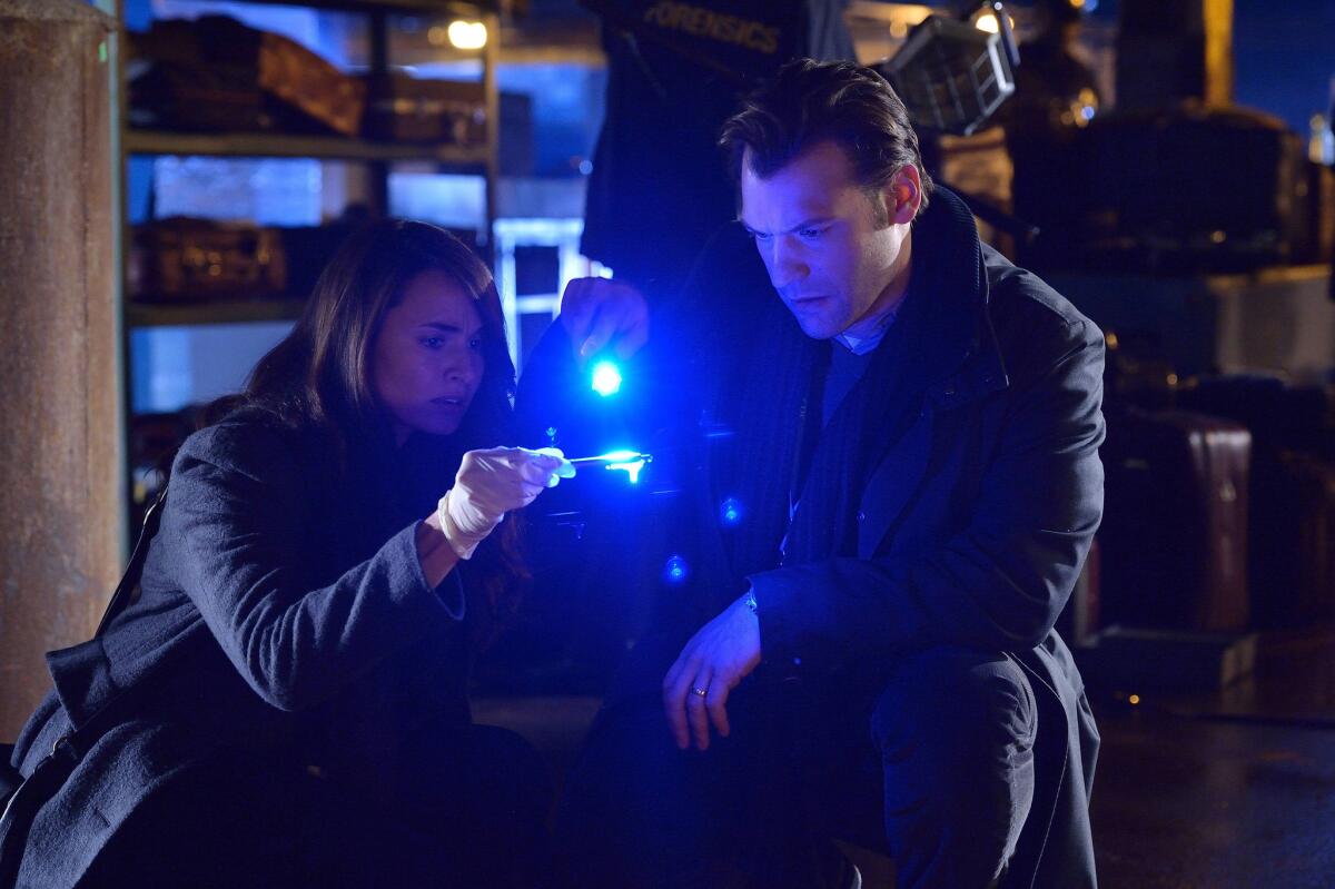 Mia Maestro as Nora Martinez, left, and Corey Stoll as Ephraim Goodweather in a scene from "The Strain."