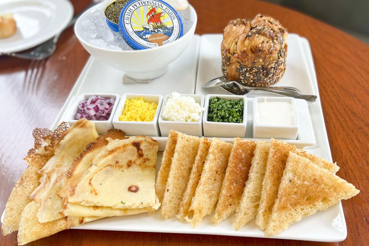 Caviar service at Saltie Girl features toast points, fresh crepes and assorted toppings