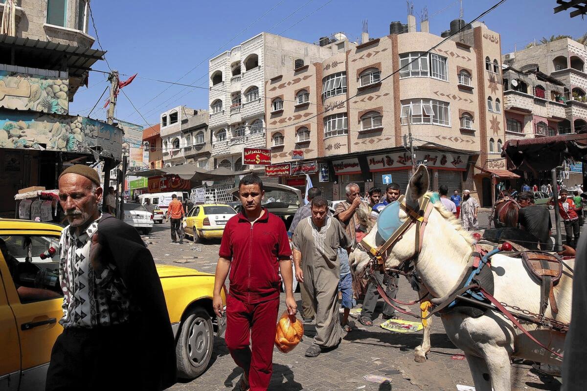 Palestinians head to the market in Jabaliya, in the Gaza Strip, to prepare for the meal to break the daily fast on the last night of Ramadan, the Muslim fasting month.