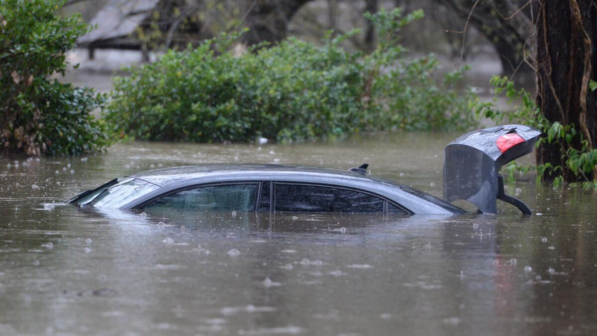 A vehicle is submerged by high water in a subdivision in Shreveport, La.