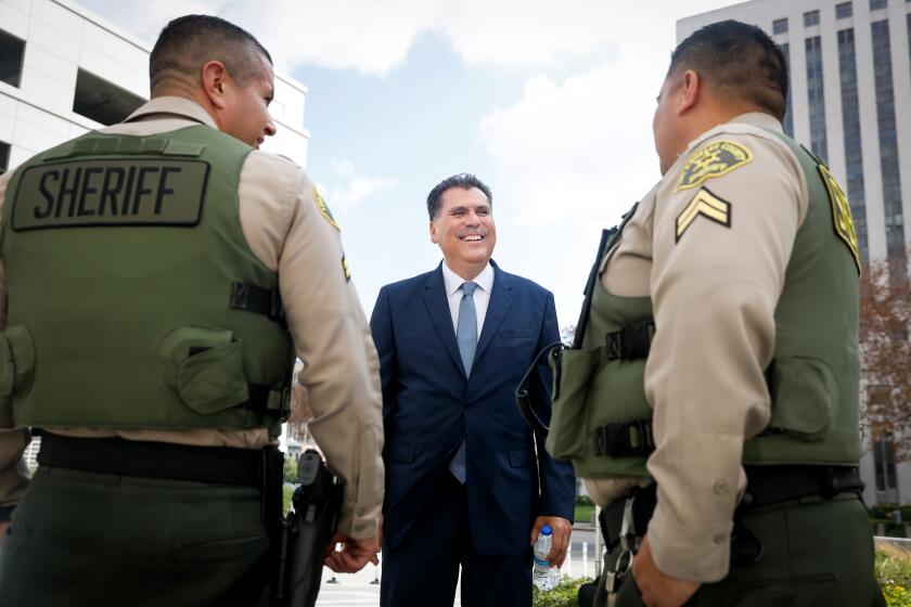 LOS ANGELES-CA - NOVEMBER 29, 2022: Sheriff-elect Robert Luna, center, chats outside LA County Sheriff's Department headquarters in downtown Los Angeles on Tuesday, November 29, 2022. (Christina House / Los Angeles Times)