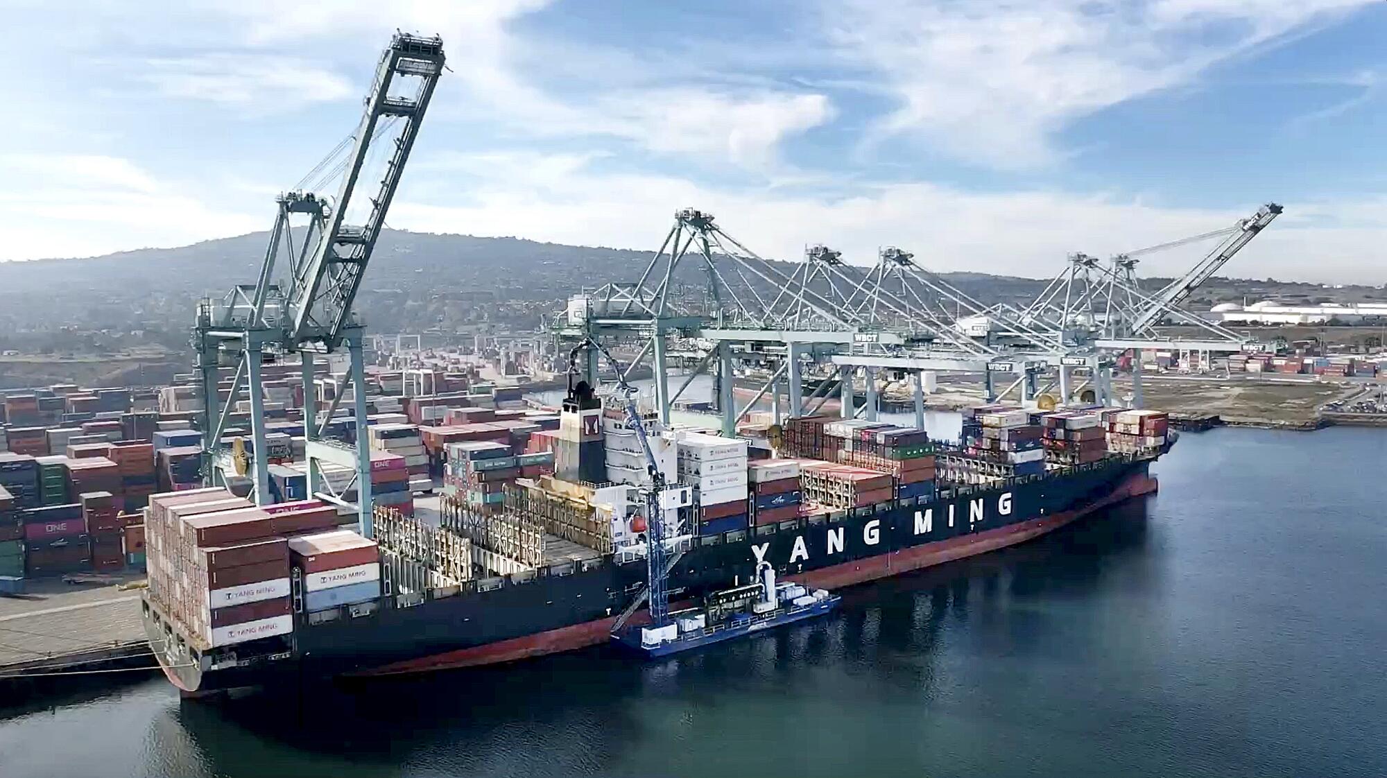 A container ship is unloaded at the Port of Los Angeles, in San Pedro, in December 2019.