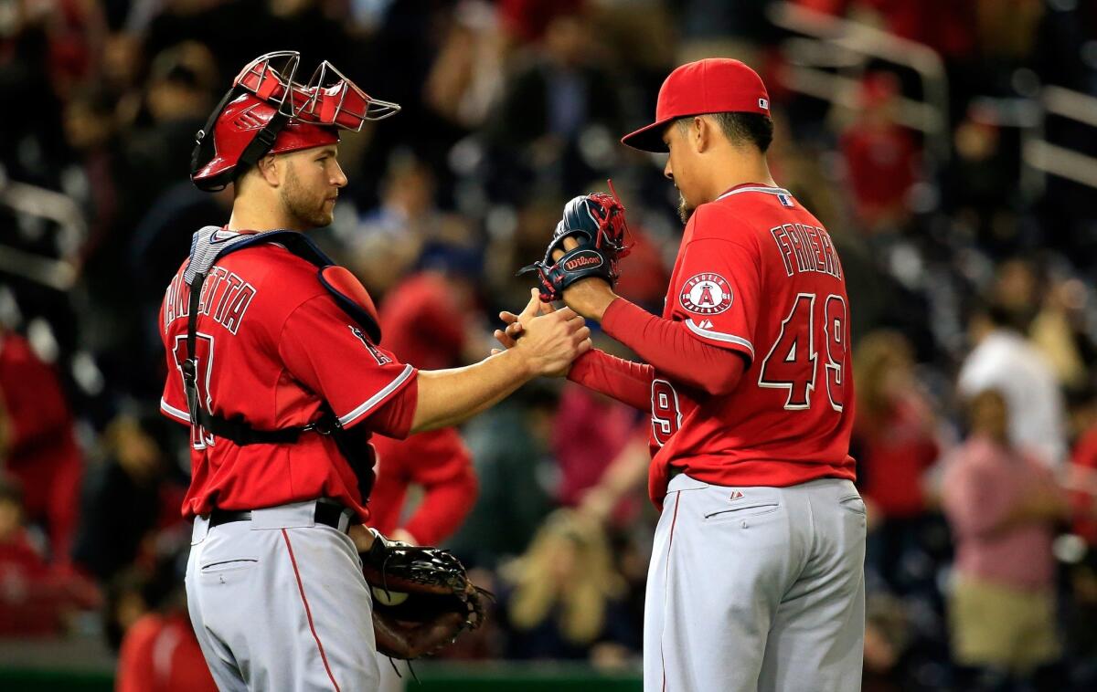 Angels catcher Chris Iannetta, left, and closer Ernesto Frieri, right, celebrate after a 4-2 win Monday over Washington at Nationals Park.