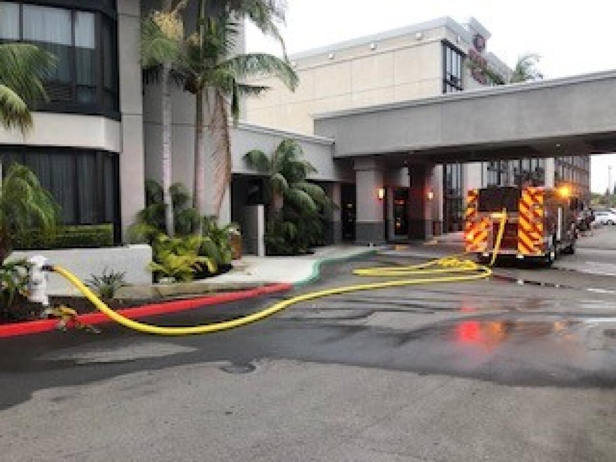 Costa Mesa Fire and Rescue crews outside a Bristol Street hotel Sunday morning.