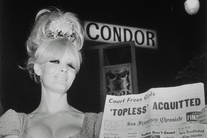A woman holds a newspaper in the documentary, "Carol Doda Topless at the Condor."