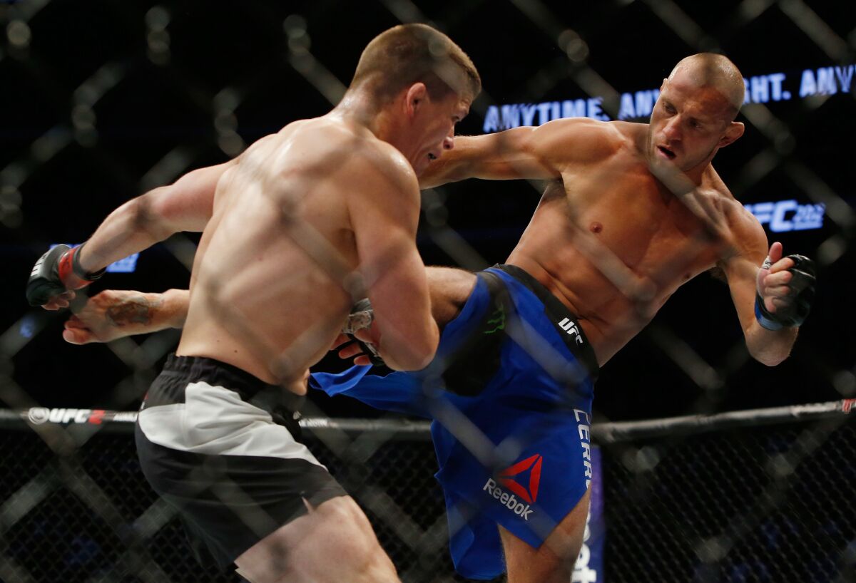 Donald Cerrone kicks Rick Story during their welterweight bout at the UFC 202.