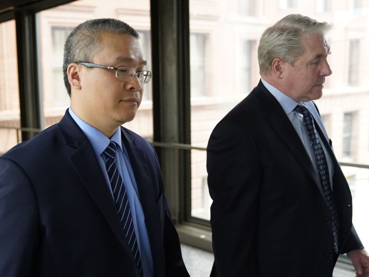 FILE - Former Minneapolis police officer Tou Thao, left, and his attorney Robert Paule arrive for sentencing for violating George Floyd's civil rights outside the Federal Courthouse Wednesday, July 27, 2022, in St. Paul, Minn. A judge has scheduled a hearing for Monday, Aug. 15, 2022, on the status of plea negotiations in the case of the two remaining officers awaiting trial on state charges in the murder of George Floyd. Thao and J. Alexander Kueng face a late October trial. (David Joles/Star Tribune via AP, File)