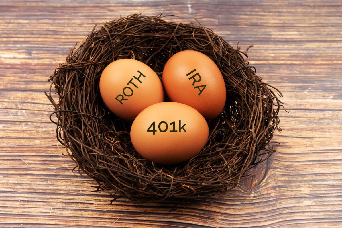 An illustration of three brown eggs sitting in a nest and labeled "Roth," "IRA" and "401k" against a wood-grain background