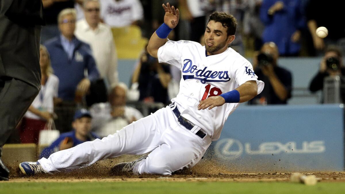 Dodgers second baseman Jose Peraza scores ahead of the throw on a single by Adrian Gonzalez during the third inning of a game against the Giants on Sept. 1.