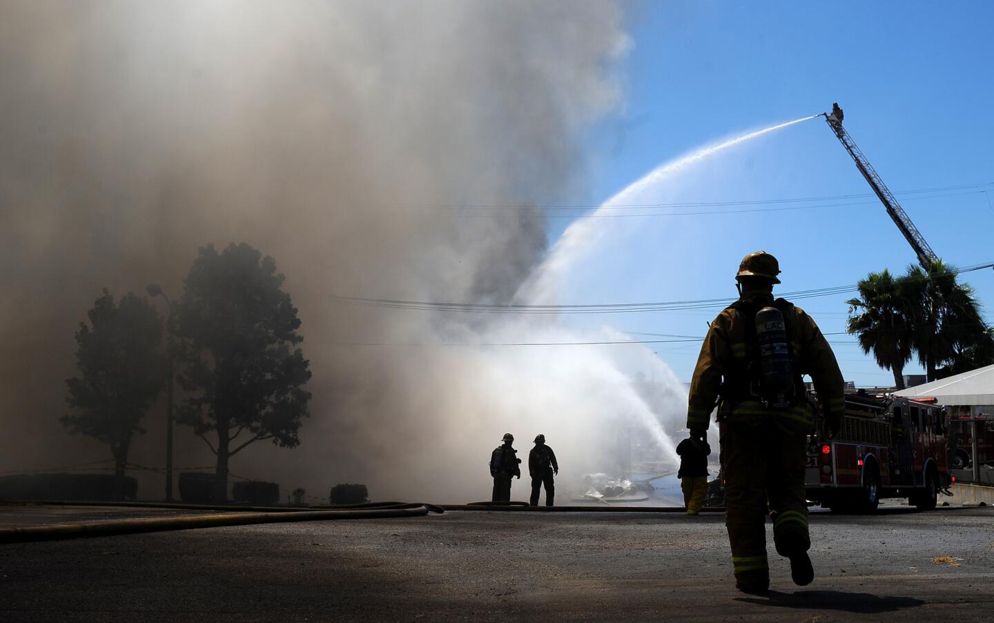 Firefighters battle a fire at the Animo South Los Angeles Charter High School along Western Ave. Tuesday afternoon.