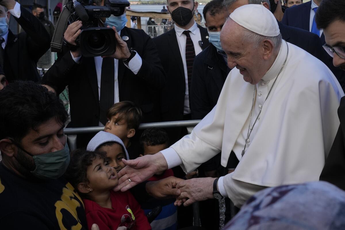 Pope Francis meets migrants at a refugee camp in Greece.