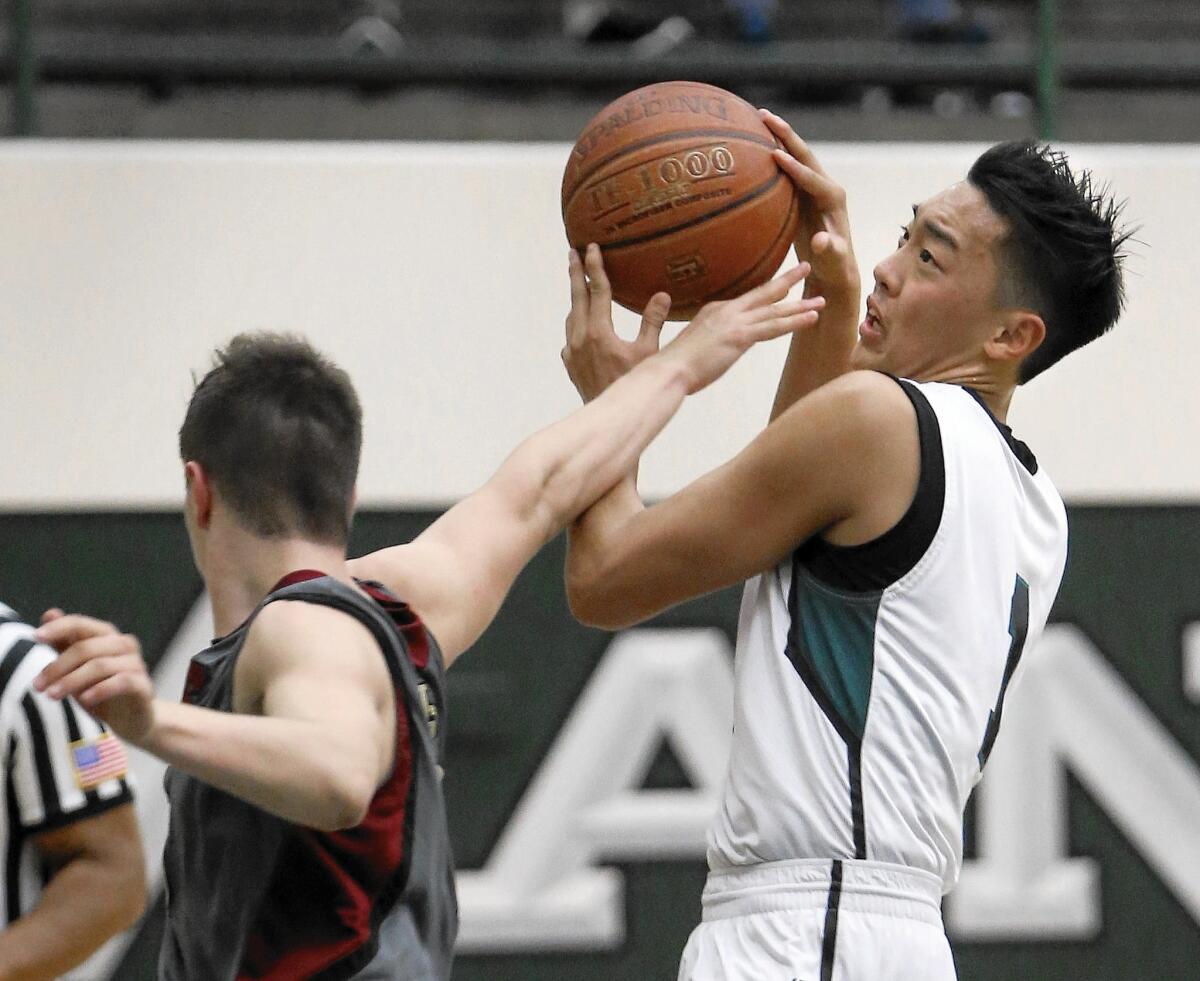 Costa Mesa High senior Calvin Ko, who scored a game-high 24 points, gets fouled on his way to the basket against JSerra.