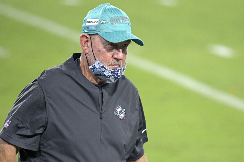 Miami Dolphins offensive coordinator Chan Gailey walks on the field before an NFL football game against the Jacksonville Jaguars, Thursday, Sept. 24, 2020, in Jacksonville, Fla. There are two Buffalo memories Dolphins offensive coordinator Chan Gailey would prefer not be brought up as Miami travels to face the Bills needing a win to clinch a playoff spot in the season finale on Sunday. The first is the teary-eyed speech Gailey provided upon being fired by the Bills following the 2012 season. The other was a 2015 loss to the Bills when he was the Jets coordinator. (AP Photo/Phelan M. Ebenhack)