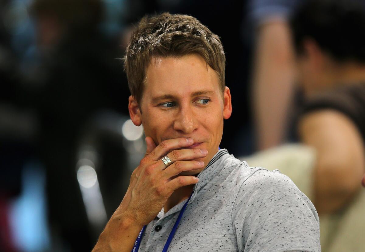 Oscar-winning screenwriter Dustin Lance Black, who was disinvited as Pasadena City College's commencement speaker, was in England on Sunday, cheering on Olympic diver Tom Daley at the FINA/NVC Diving World Series at the London Aquatics Centre.