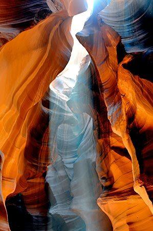 Sunlight streams through Antelope Canyon, near Page, Ariz. The sandstone has been sculpted over the years by floodwater, rain and wind.