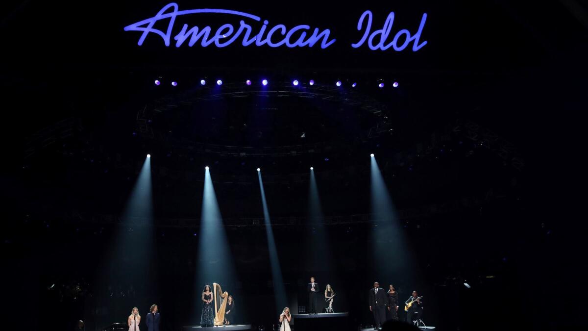 Katherine McPhee, from left, Casey James, Carly Smithson, Jessica Sanchez, Clay Aiken, Ruben Studdard and Amber Holcomb perform at the "American Idol" farewell season finale in 2016.