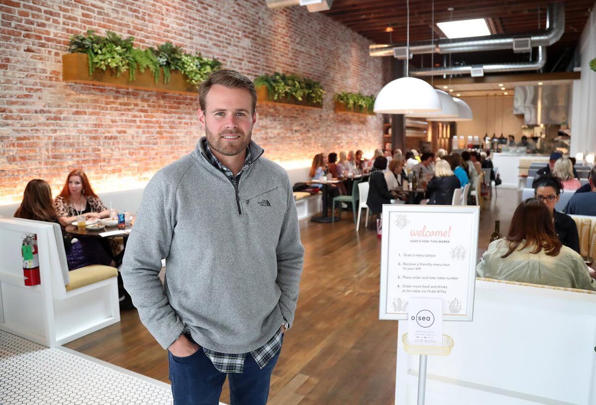 Owner Mike Flynn stands at the O Sea restaurant in Old Town Orange.