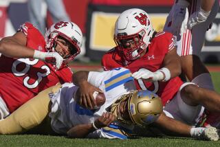 Utah's Jonah Elliss (83) and Logan Fano (0) sack UCLA quarterback Dante Moore.