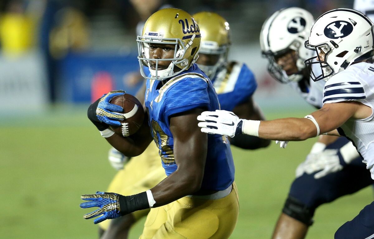 UCLA linebacker Myles Jack runs with the ball after an interception against BYU on Sept. 19.