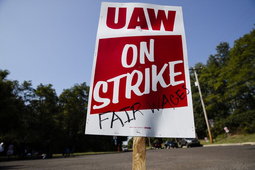 FILE - A sign is posted during a demonstration outside a General Motors facility in Langhorne, Pa., on Sept. 23, 2019. Reform-minded candidates won several races Sunday, Dec. 4, 2022, as members of the United Auto Workers union voted on their leaders in an election that stemmed from a federal bribery and embezzlement scandal involving former union officials. (AP Photo/Matt Rourke, File)
