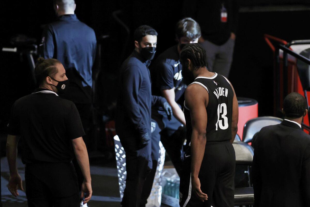 Brooklyn Nets guard James Harden (13) leaves the court early in the first quarter against the Milwaukee Bucks during Game 1 of an NBA basketball second-round playoff series Saturday, June 5, 2021, in New York. (AP Photo/Adam Hunger)