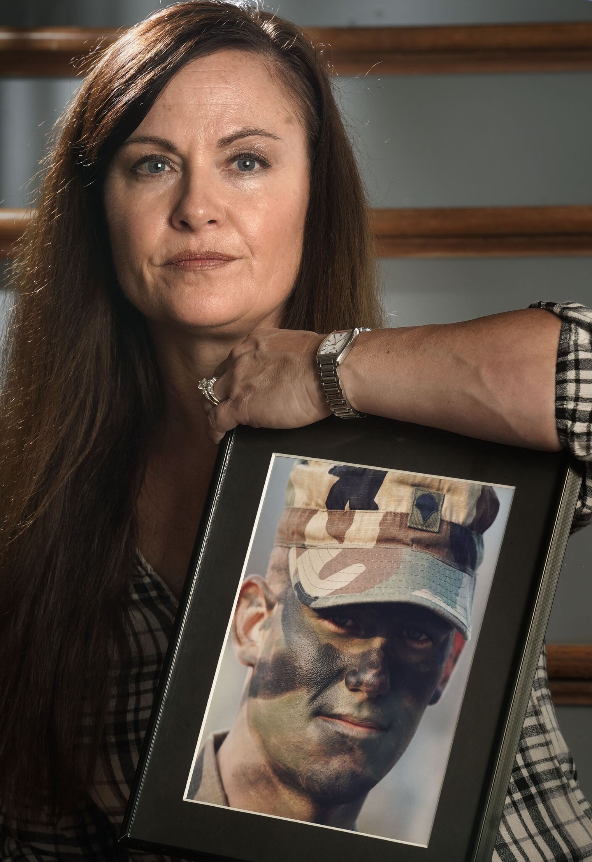 Widow Shawna Blue holds a photo of her husband Brian Cody Prosser