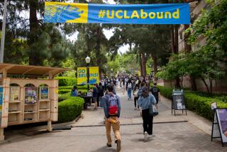 Los Angeles, CA - May 17: Signage and people along Bruin Walk East, near Bruin Plaza, on the UCLA Campus in Los Angeles, CA, Wednesday, May 17, 2023. (Jay L. Clendenin / Los Angeles Times)