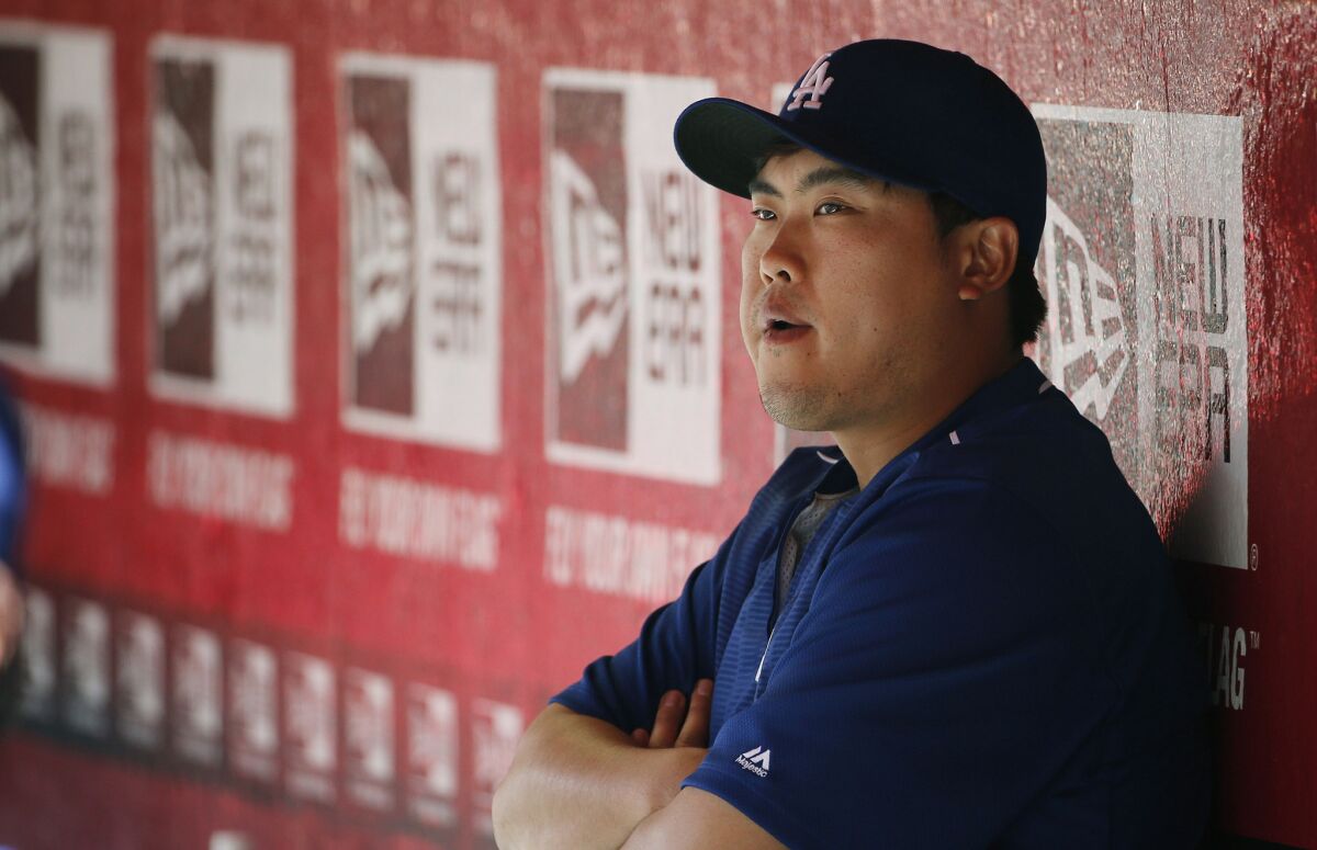 Dodgers pitcher Hyun-Jin Ryu, on the 60 day disabled list with a shoulder injury, watches his teammates from the dugout against the Arizona Diamondbacks on April 12.