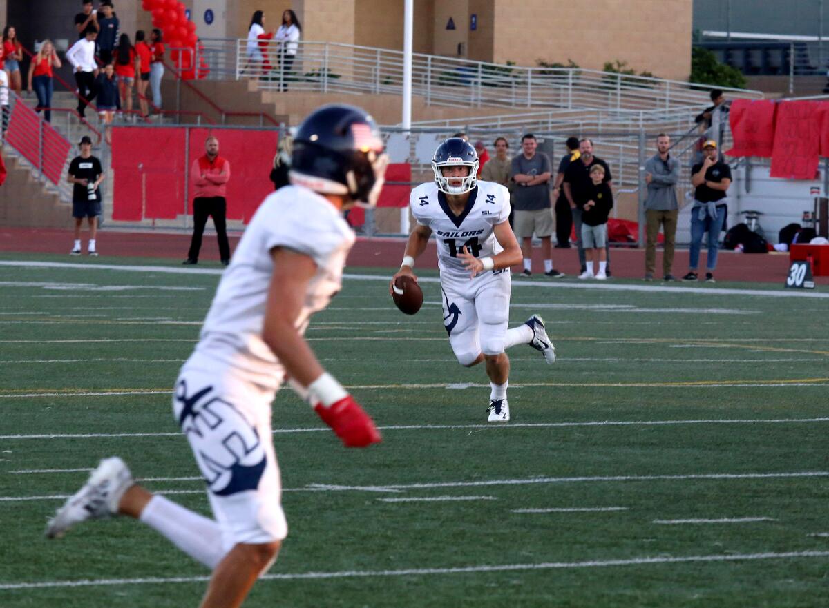 Newport Harbor quarterback Cole Lavin looks for an open player in Friday's season opener against Woodbridge at University High in Irvine.