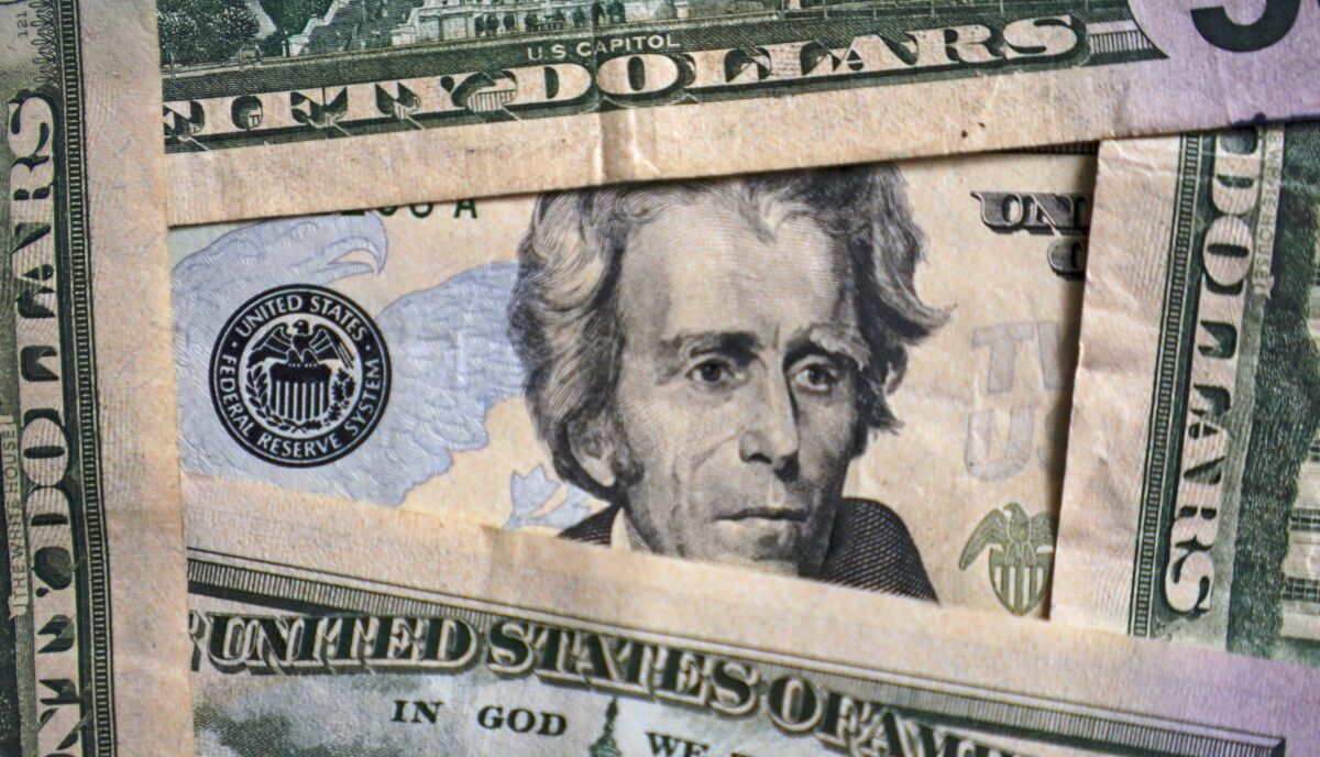 FILE - Photo of Andrew Jackson on a $20 bill is shown, Friday, Jan. 28, 2022, in Cleveland. Worrying about overall financial issues can make people less likely to plan for retirement, according to a 2021 report. If you don’t have enough saved for your golden years, it could mean retiring later than you planned or running out of money during retirement. (AP Photo/Tony Dejak, File)