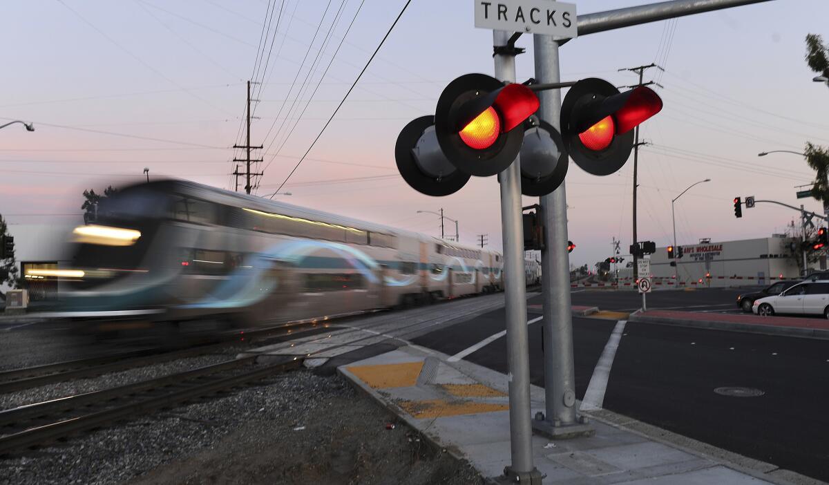 A Metrolink train crosses the intersection of Rosecrans Avenue and Marquardt Avenue in Santa Fe Springs.