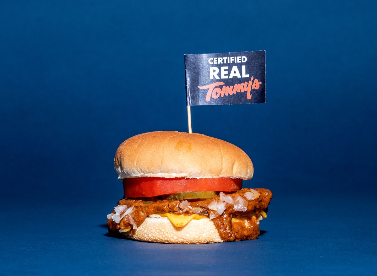 A chili burger with a little sign on a toothpick that says "Certified Real Tommy's."