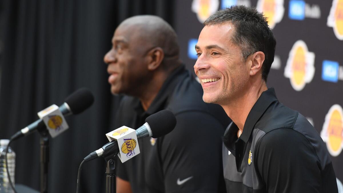 Lakers General Manager Rob Pelinka, right, and President of Basketball Operations Earvin "Magic" Johnson answer questions during a press conference in El Segundo on Thursday.