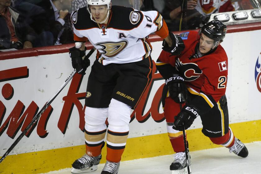 Ducks forward Corey Perry battles with Mason Raymond, then with the Calgary Flames, in March 2015.