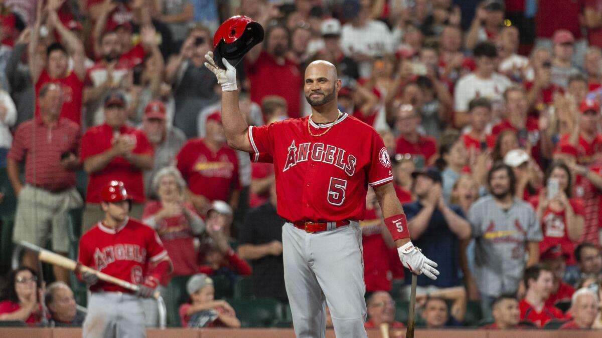 Angels slugger Albert Pujols tips his helmet to the crowd before his final at bat against the St. Louis Cardinals on Sunday night.