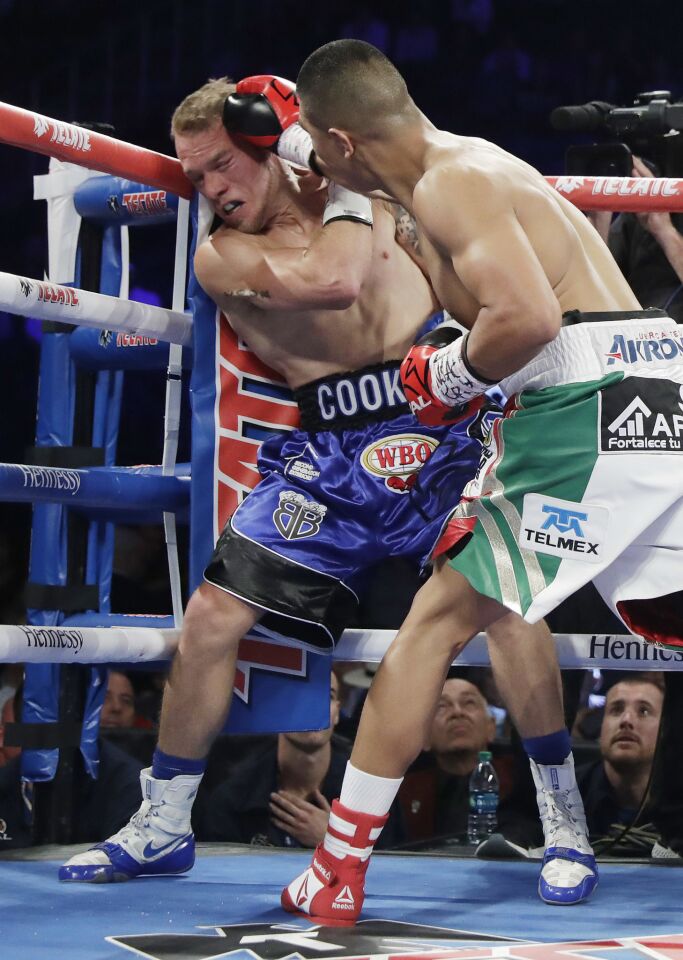Jaime Munguia, right, punches Brandon Cook during their WBO junior middleweight championship boxing match, Saturday, Sept. 15, 2018, in Las Vegas. Munguia won by TKO.