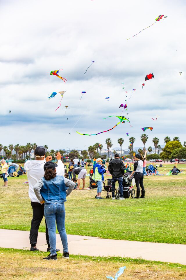 Juan and Christina Cabrera go fly a kite at the OB Kite Festival.
