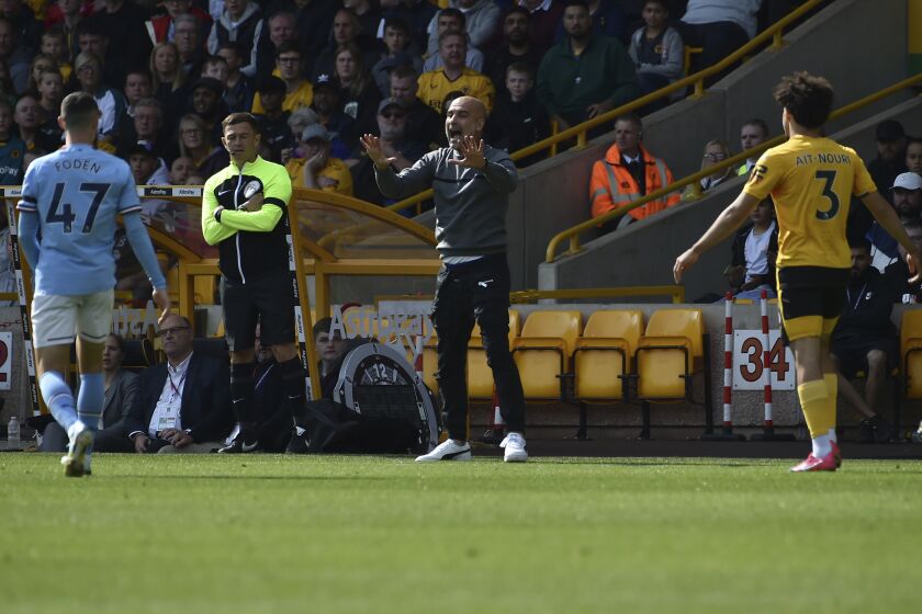 Manchester City's head coach Pep Guardiola gives directions to his players during the English Premier League soccer match between Wolverhampton Wanderers and Manchester City at Molineux stadium in Wolverhampton, England, Saturday, Sept. 17, 2022. (AP Photo/Rui Vieira)