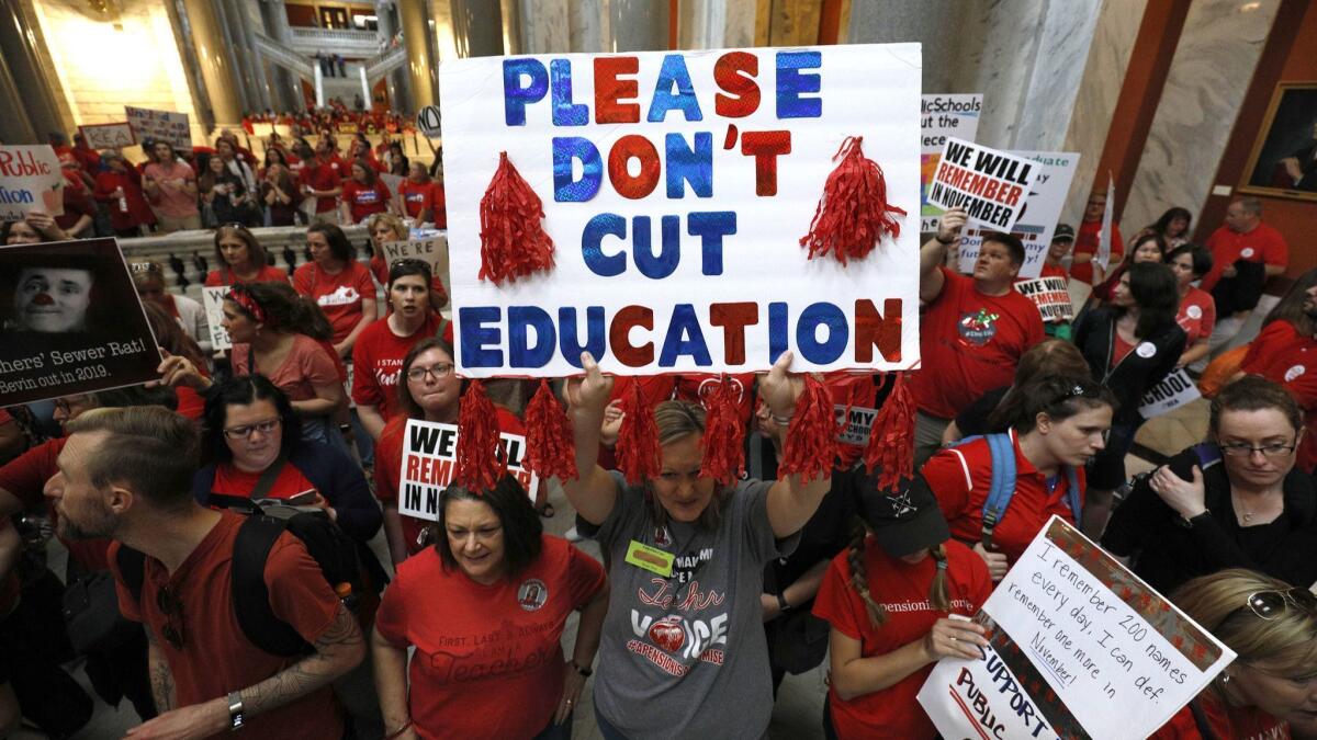 Kentucky public school teachers protest at the state capitol in Frankfort on April 13, 2018.