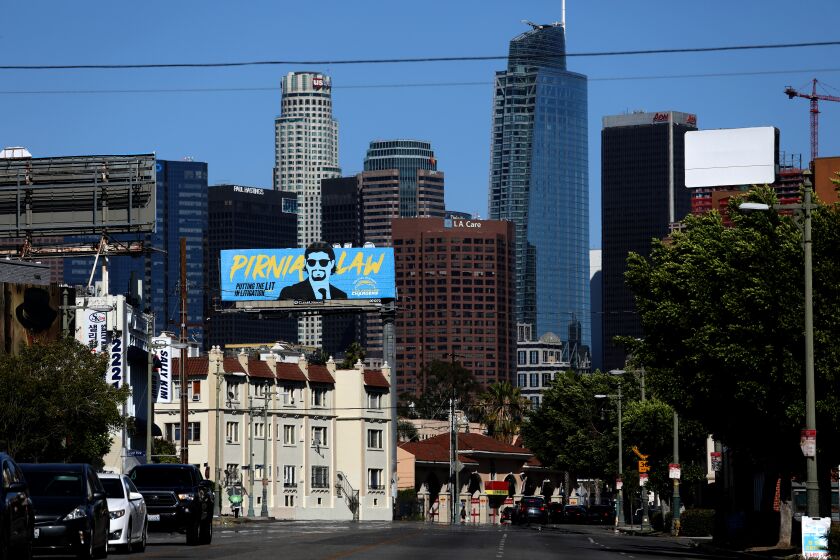 LOS ANGELES, CA - MAY 12: The down town skyline seen from the Pico-Union neighborhood along Olympic Blvd. on Thursday, May 12, 2022 in Los Angeles, CA. Overcrowded housing in Pico-Union, considered the most overcrowded neighborhood in Los Angeles. (Gary Coronado / Los Angeles Times)