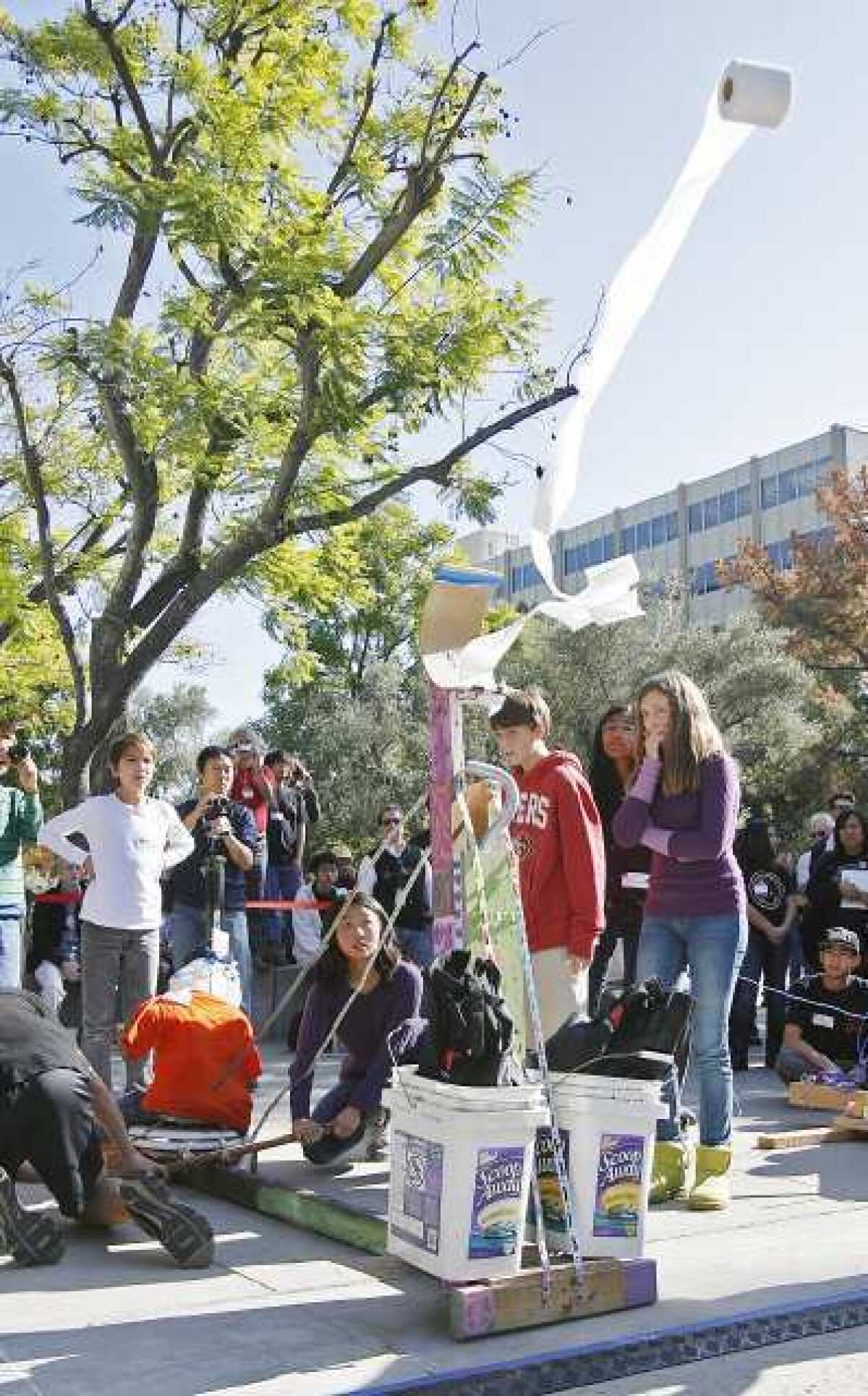 South Pasadena High School's catapult is triggered and a roll of toilet paper flies forward in the JPL Invention Challenge. High school teams propelled tissue rolls catapults.